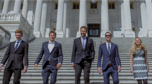 7 people from Protect Our WInters walking down the steps of the US capital